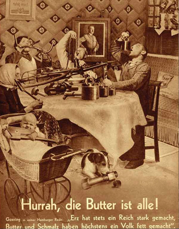 John Heartfield “Hurrah, the Butter Is All Gone!” (1935) – German family eating metal objects, anti-Nazi photomontage