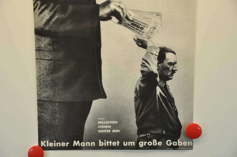 John Heartfield “The Meaning of the Hitler Salute” (1932) – satirical photomontage of tiny Hitler receiving money