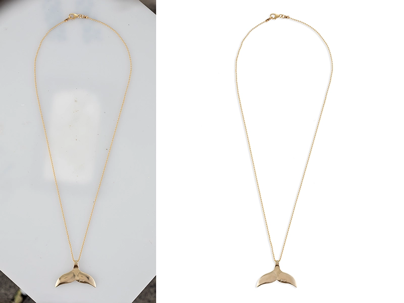 A retouched photo of a gold jewelry piece isolated on a white background. The gold chain with pendant is retouched for sale on marketplaces.