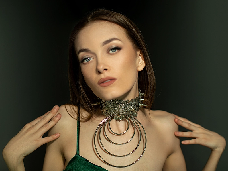 Retouching a close-up studio shot of a model with fantastic jewelry for an influencer advertising campaign. Natural facial retouching, color correction, and high-quality imagery for advertising products.